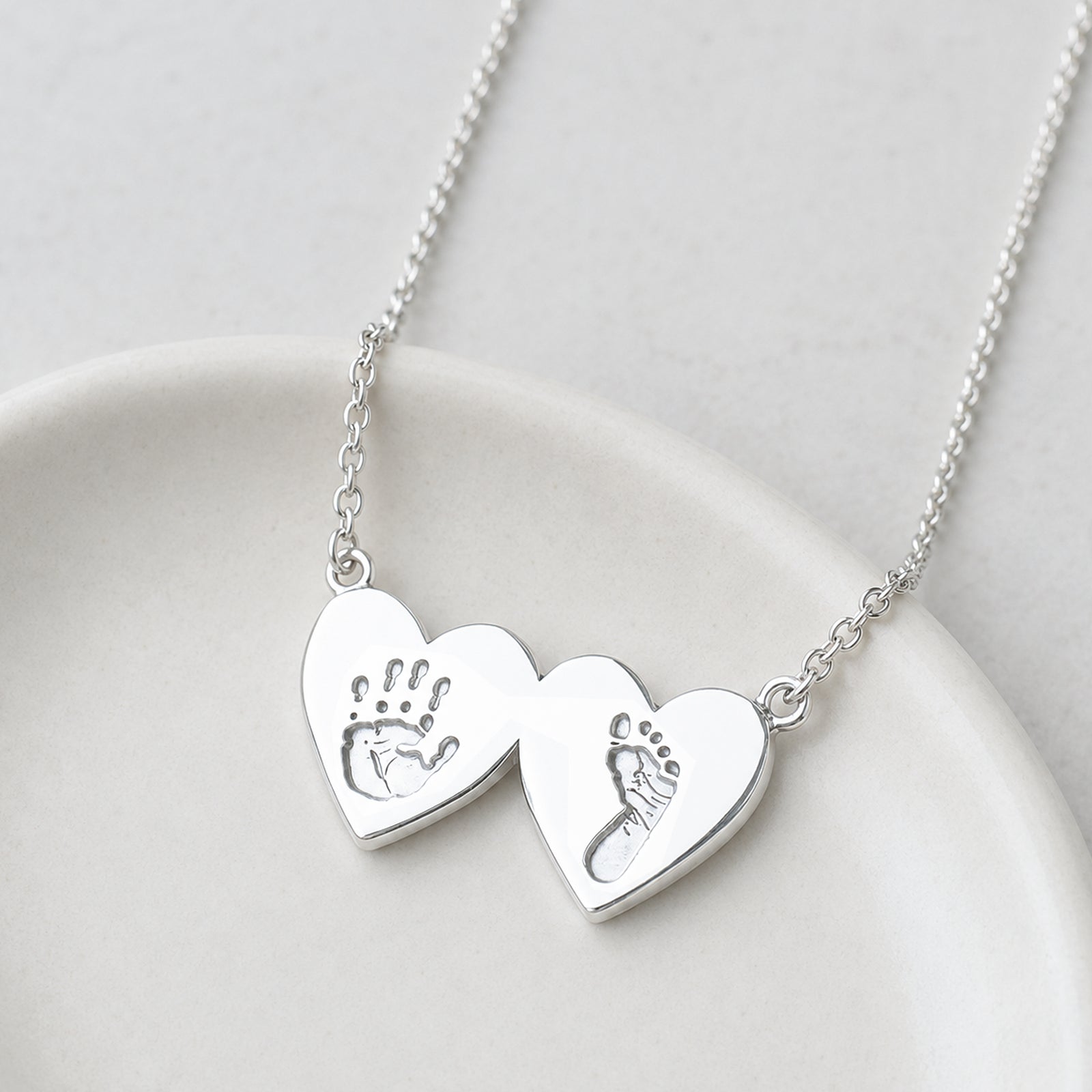 baby handprint and footprint keepsake necklace for two children