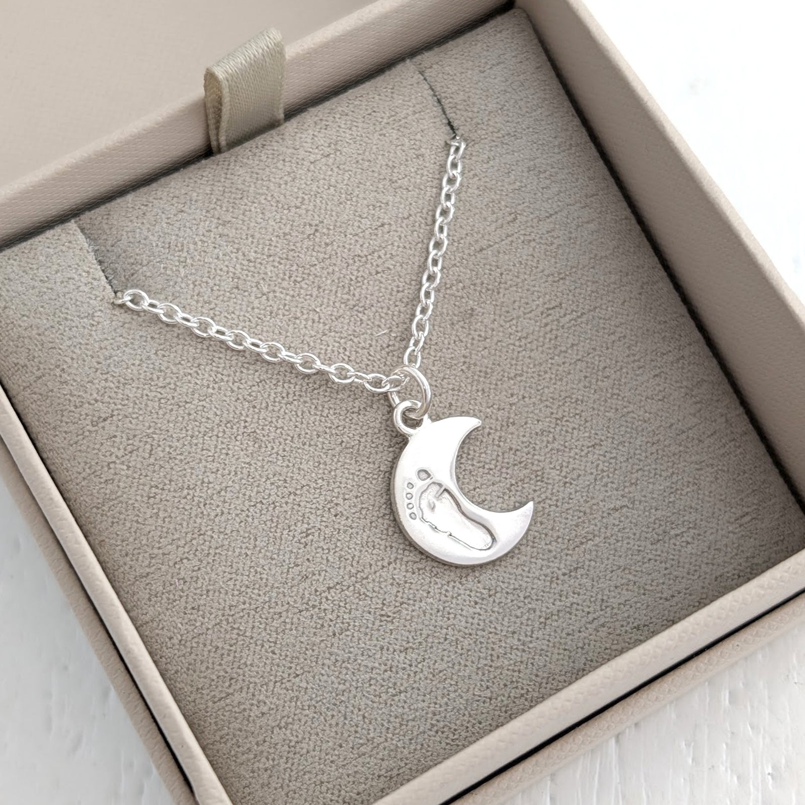 Silver baby print charm jewellery featuring engraved infant handprint and footprint keepsake - moon charm