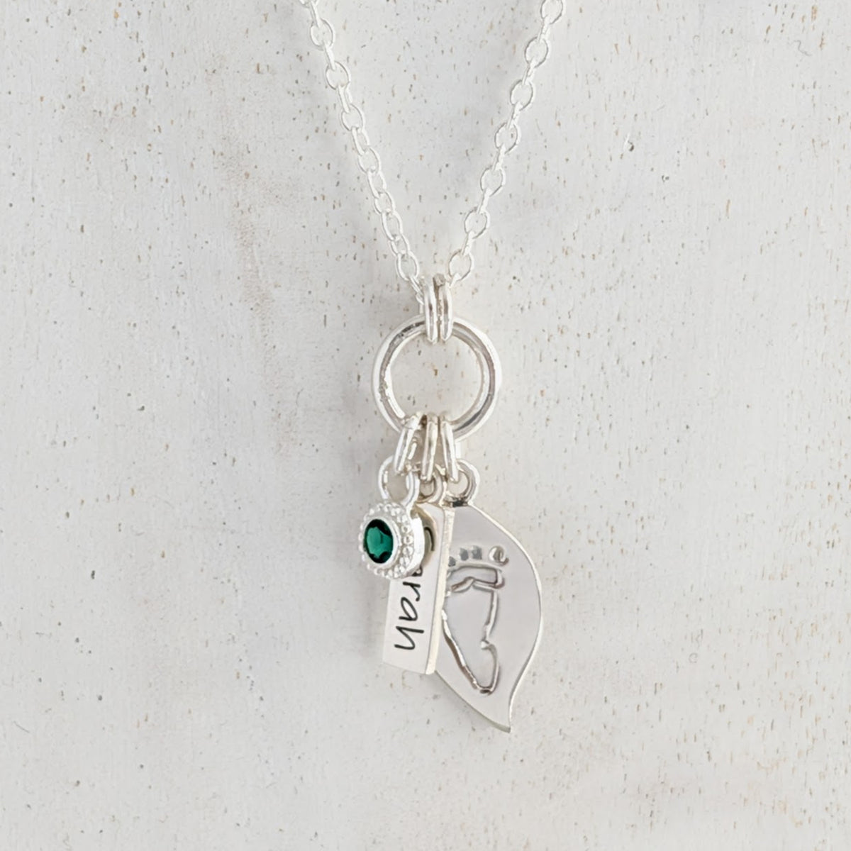Leaf and nature nspired silver necklace engraved with child's own handprint or footprint and birthstone.