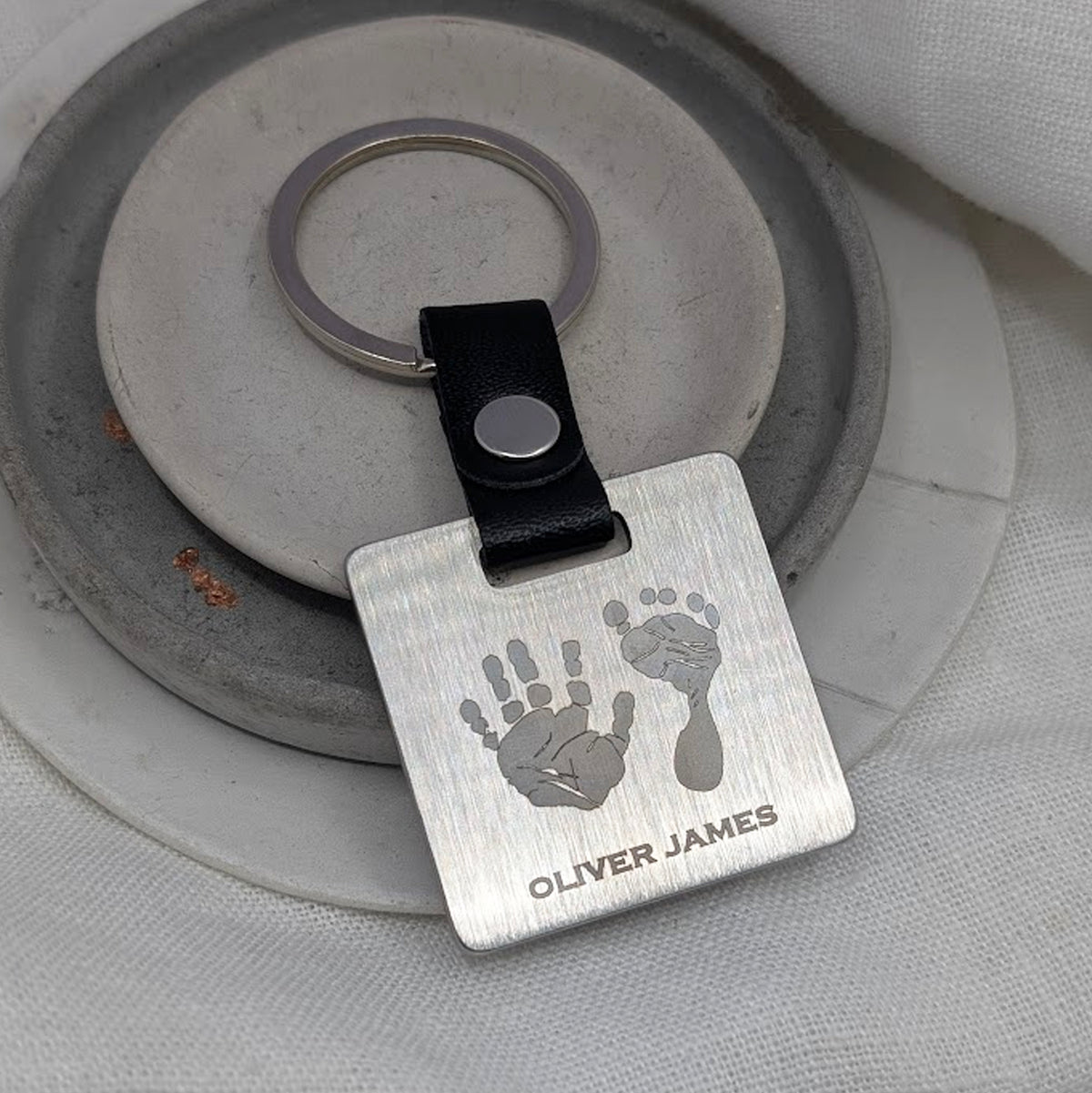HAND &amp; FOOTPRINT STEEL SQUARE KEYRING
