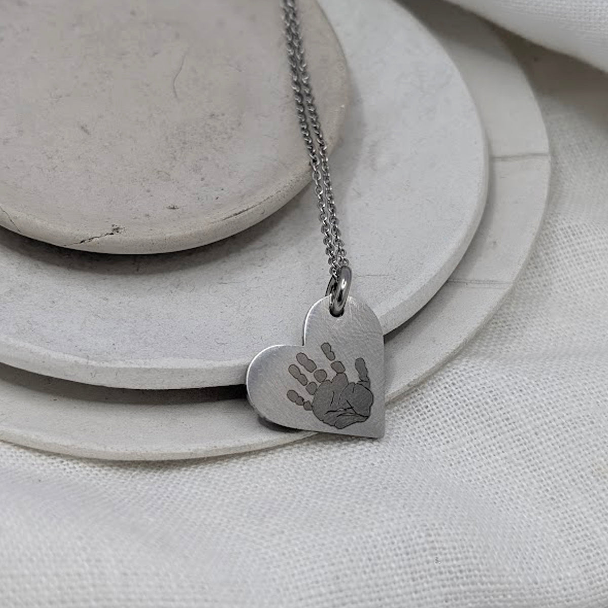 HANDPRINT STEEL HEART NECKLACE