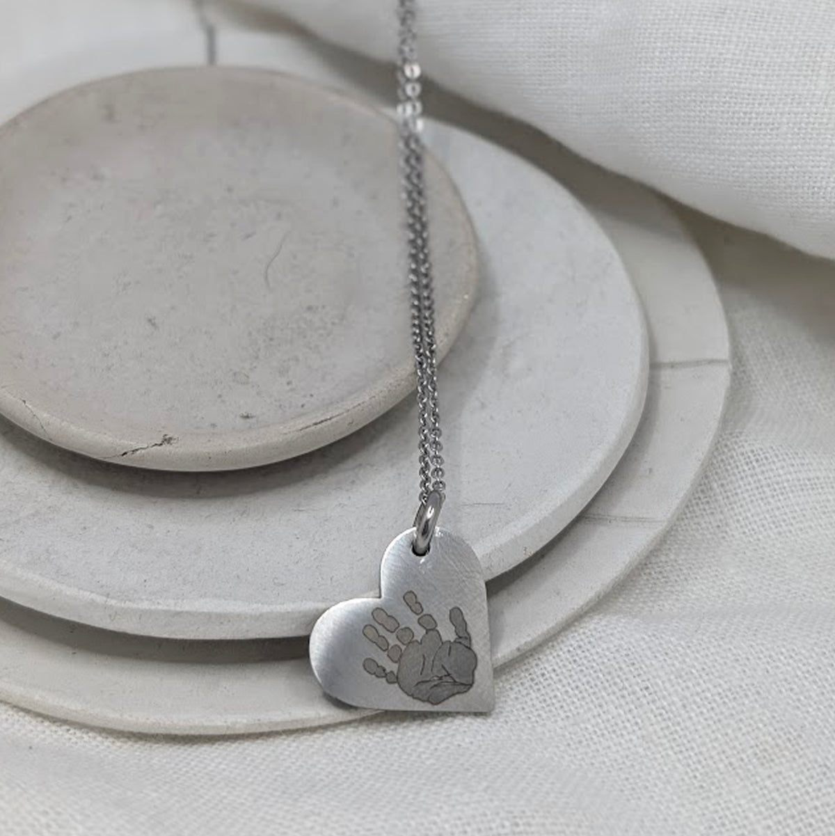 HANDPRINT STEEL HEART NECKLACE