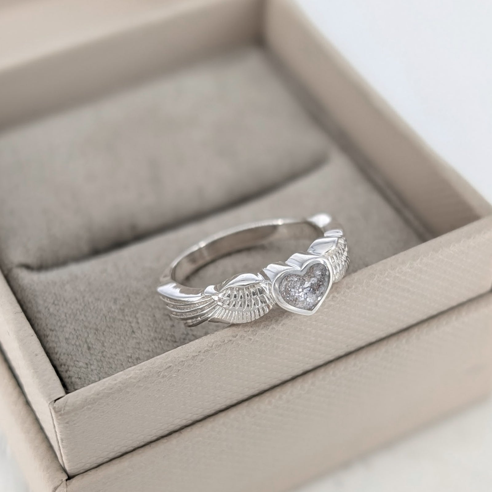 Memorial Ashes Angel Wings Ring with heart shaped bezel holding cremation ashes
