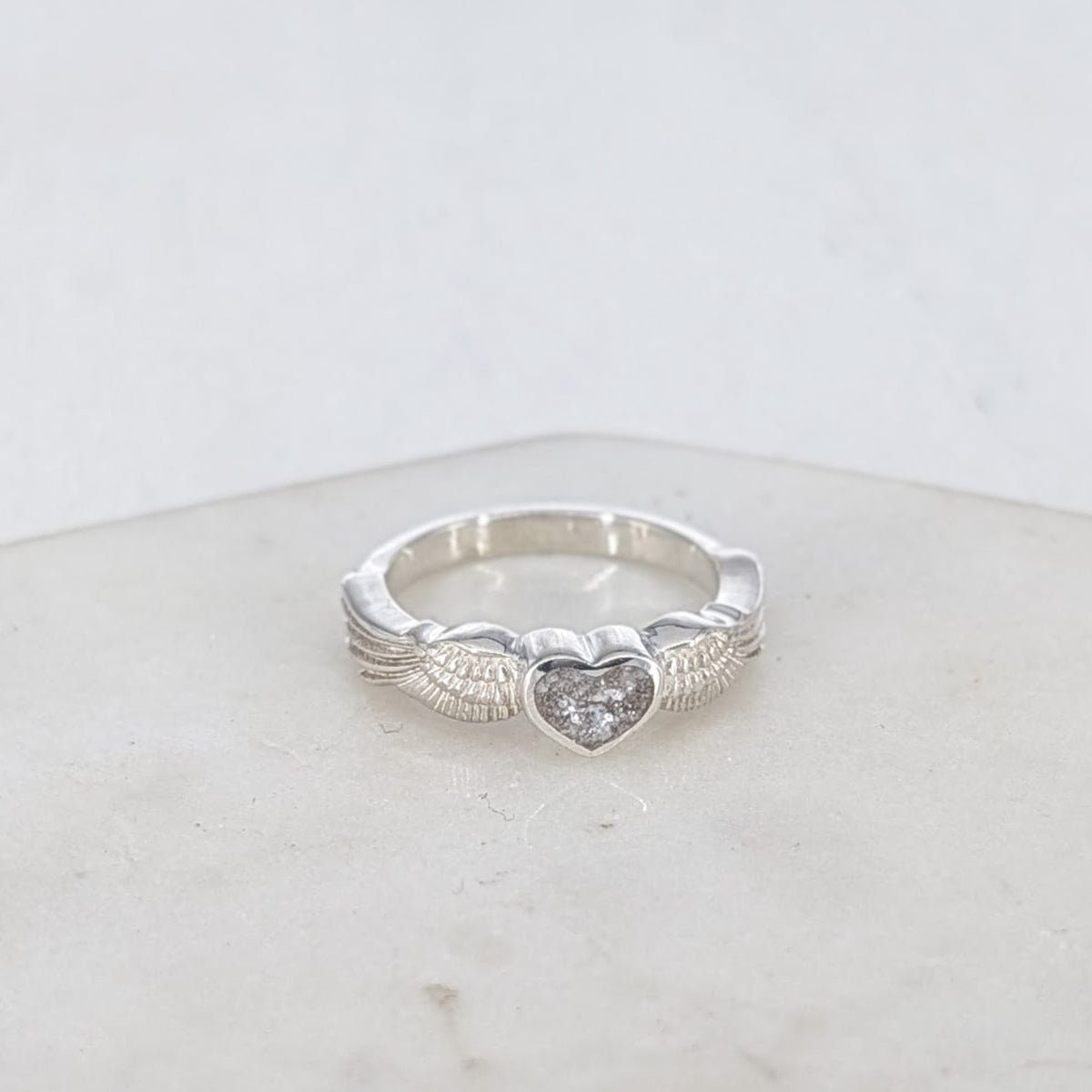 Cremation Ashes Angel Wings Ring with heart shaped bezel holding memorial ashes