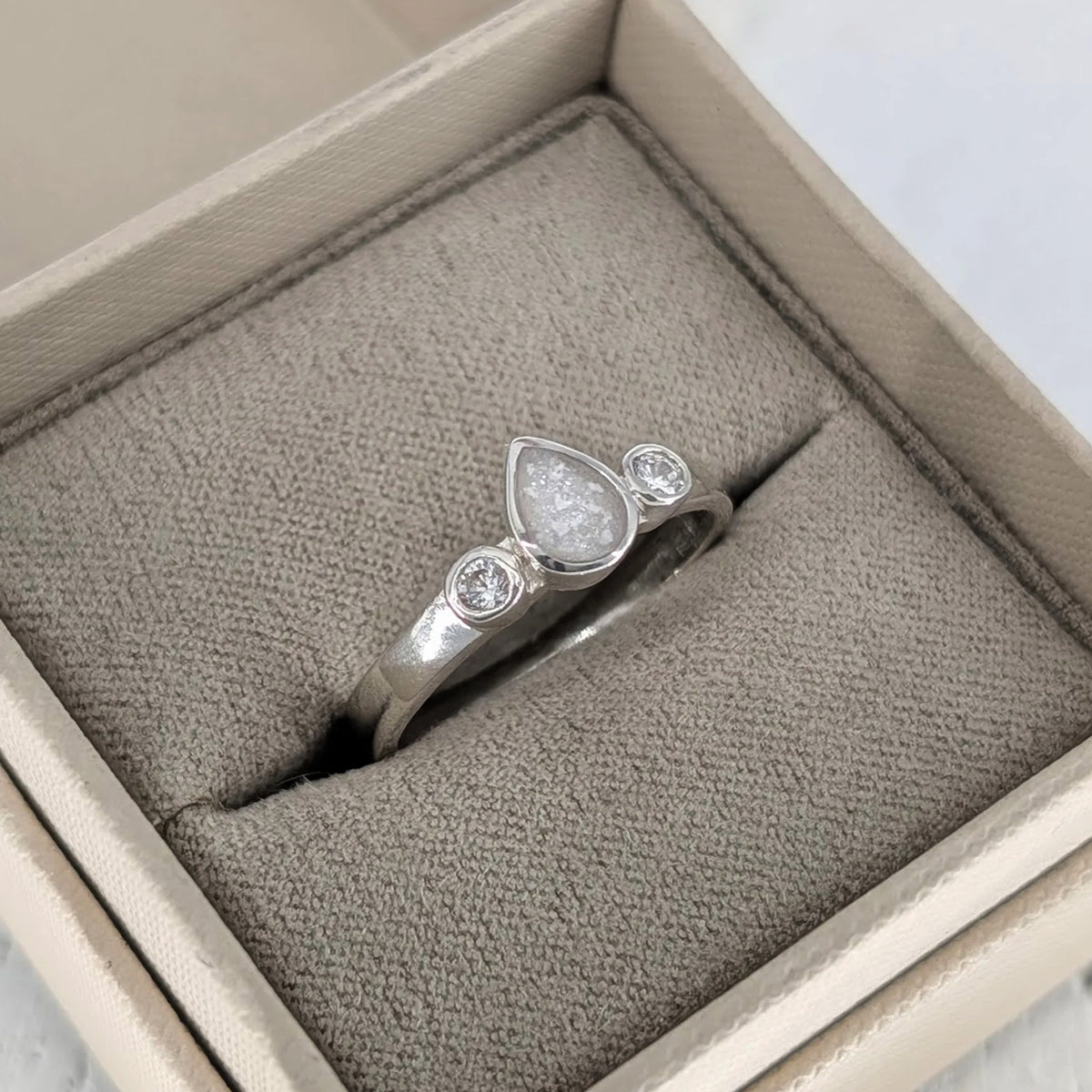 Sterling silver teardrop cremation ashes ring with sparkling cubic zirconia stones