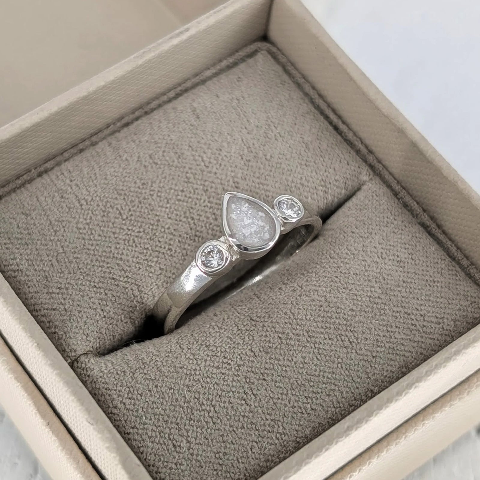 Sterling silver teardrop cremation ashes ring with sparkling cubic zirconia stones