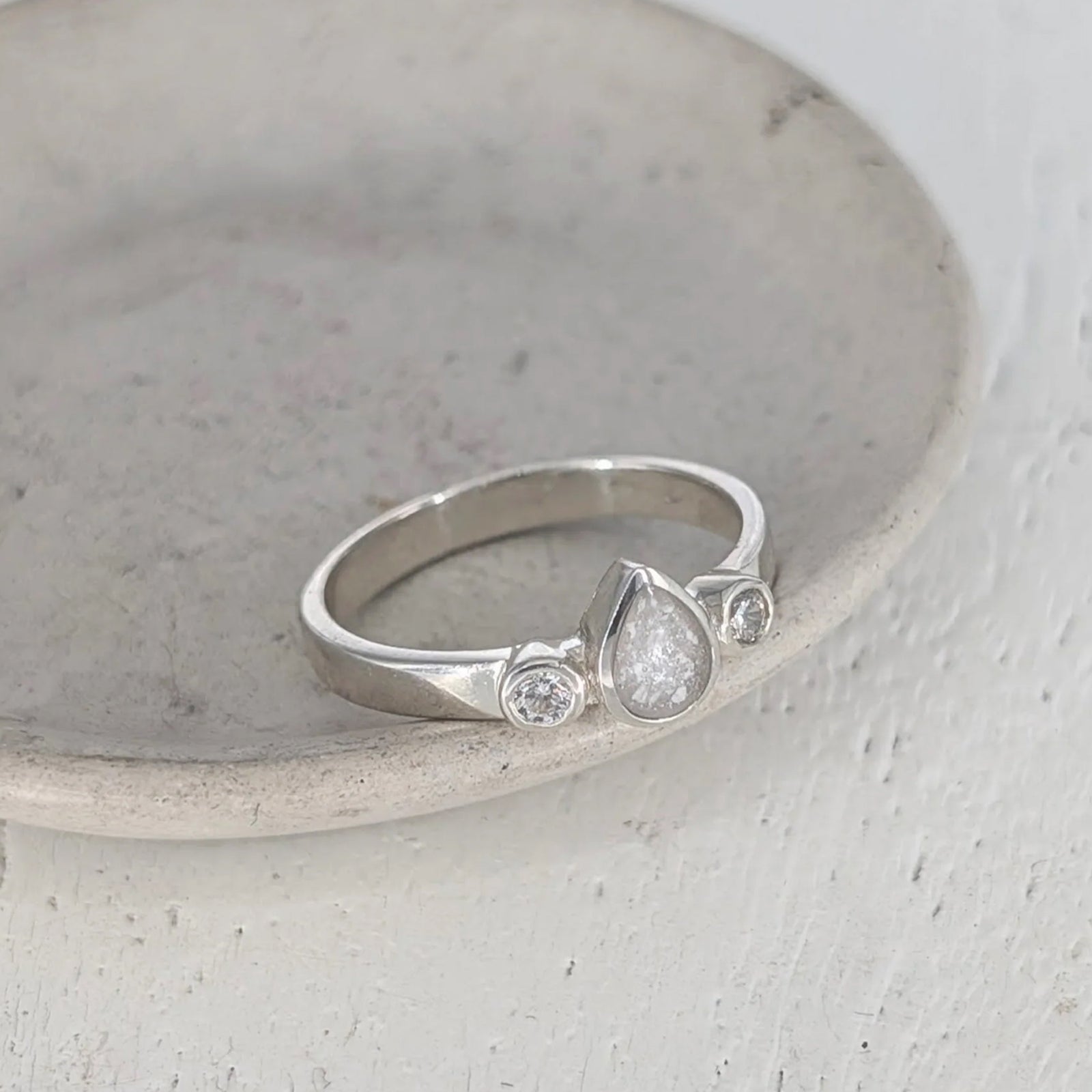 Sterling silver teardrop cremation ashes ring with sparkling cubic zirconia stones