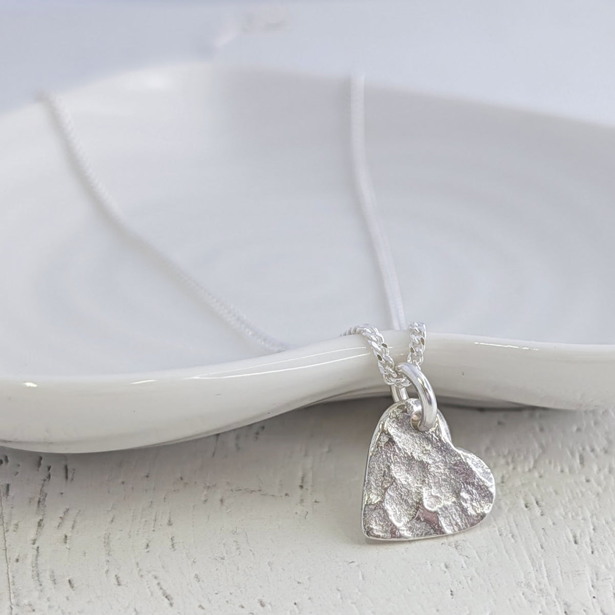Sterling silver memorial ashes heart necklace handcrafted with the impression of cremation ashes, creating a beautifully textured keepsake to honour a loved one.
