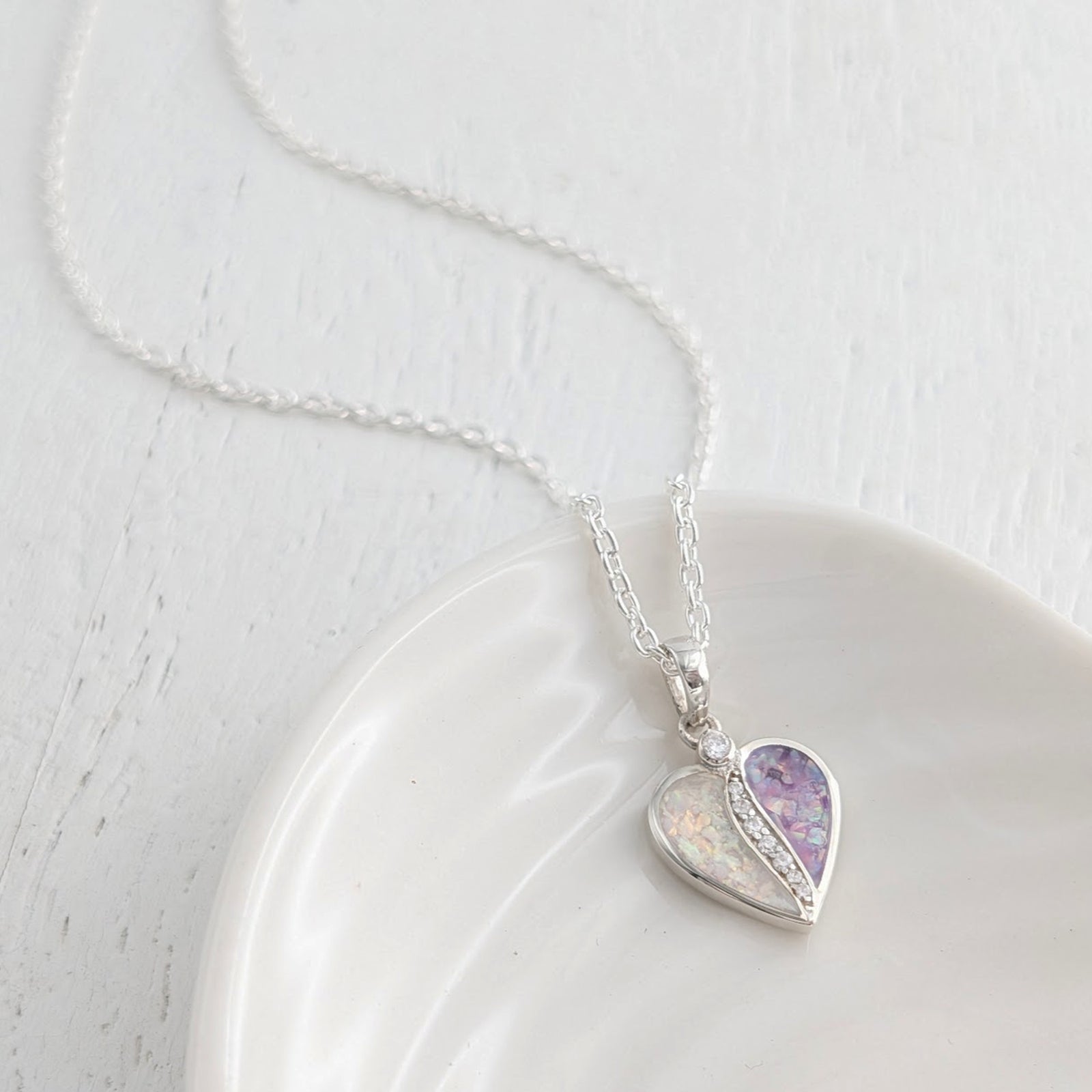 Memorial ashes split heart pendant with two coloured sections for cremation ashes, set with cubic zirconia on a sterling silver necklace