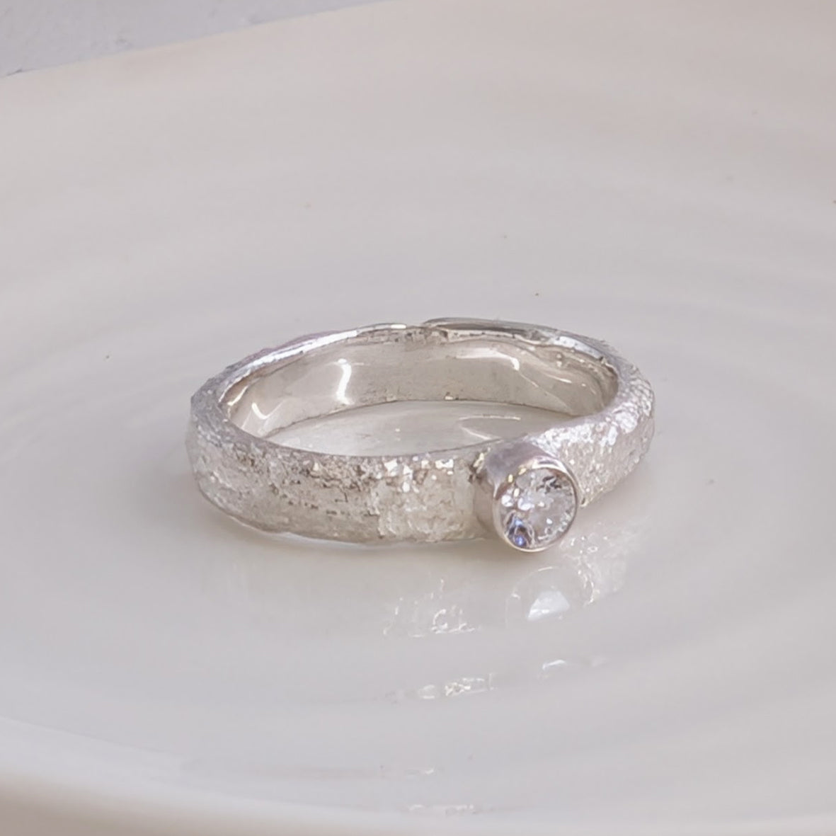 Molten silver organic cremation ashes ring set with gemstone