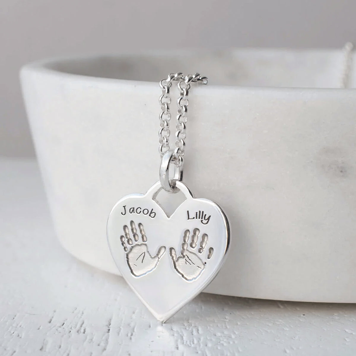Silver handprint heart necklace with two handprints