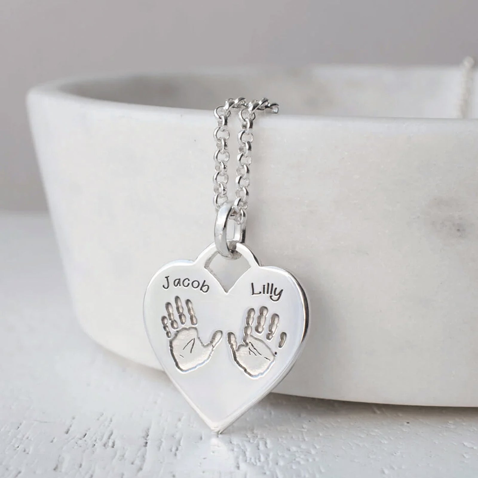 Silver handprint heart necklace with two handprints