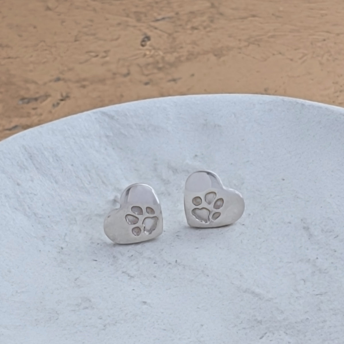 Handmade sterling silver heart pawprint earrings created from your dog's or cat's unique paw print. Beautiful pet memorial earrings and keepsake jewellery for animal lovers.