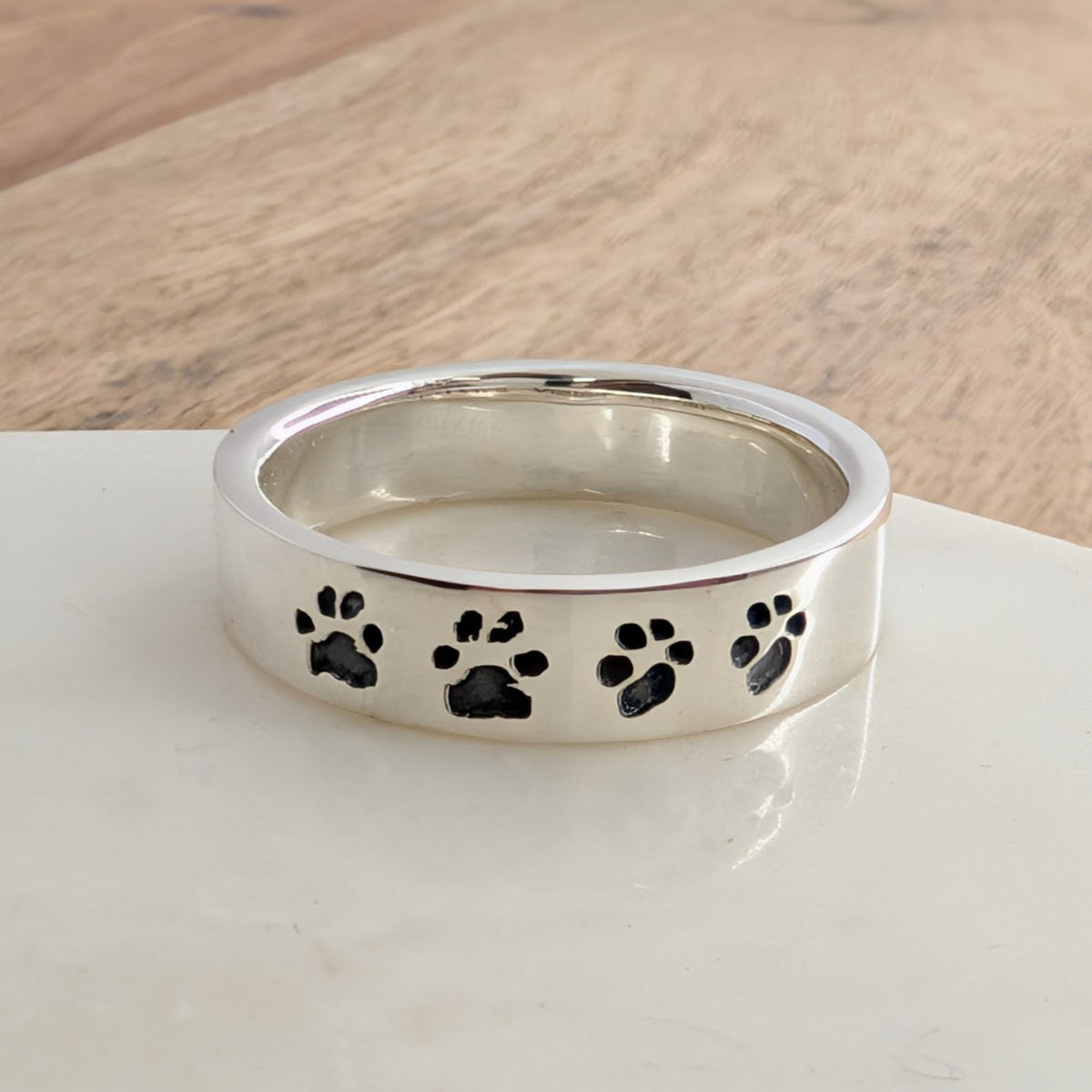 Personalised Pawprint Ring in Sterling Silver or Gold – Handmade pawprint ring engraved with your pet's unique paw prints. Crafted in sterling silver or solid gold as a meaningful pet memorial or keepsake ring.