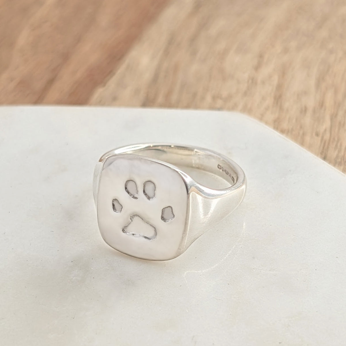Personalised paw print ring in sterling silver, handcrafted pet memorial jewellery capturing a beloved dog or cat's unique pawprint.
