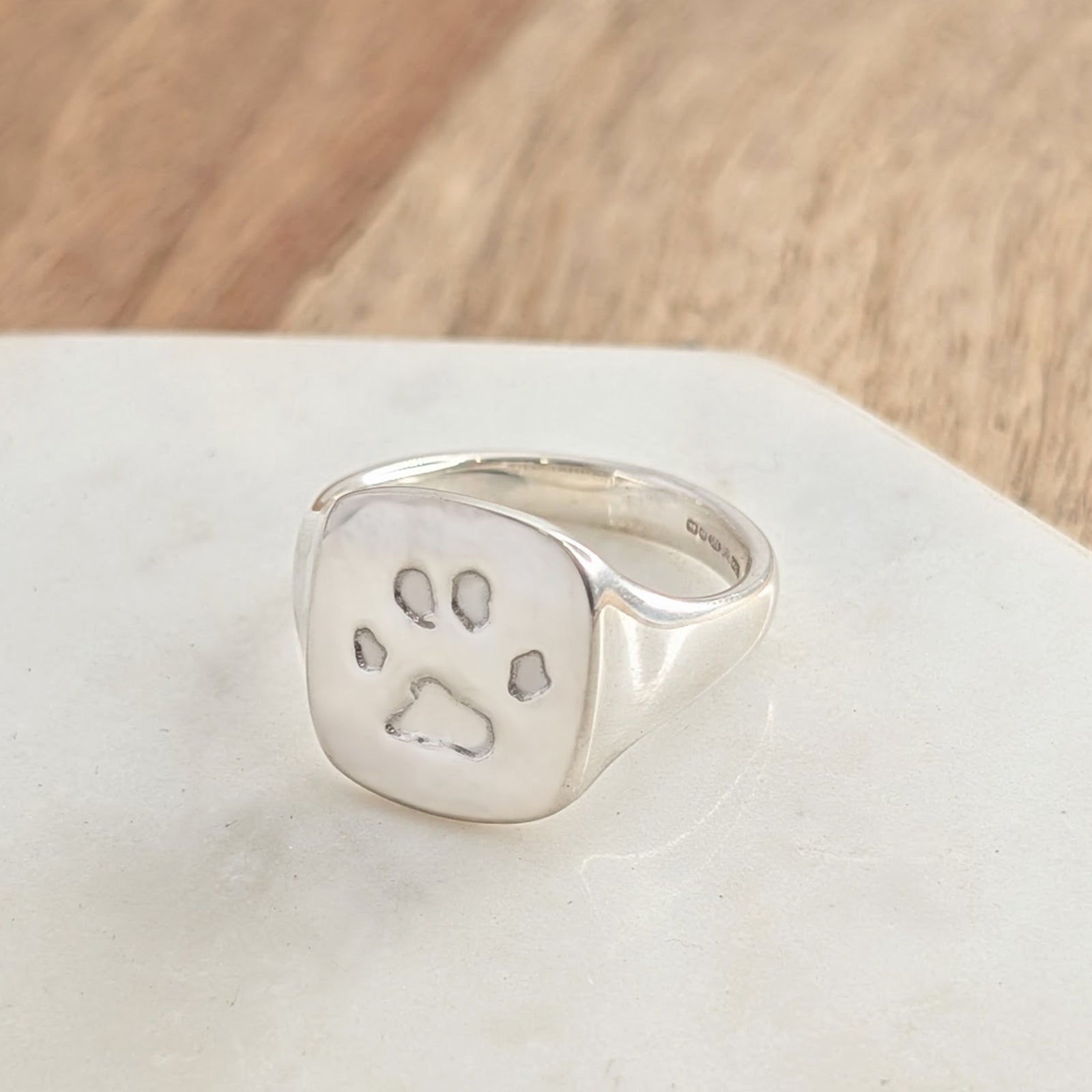 Personalised paw print ring in sterling silver, handcrafted pet memorial jewellery capturing a beloved dog or cat's unique pawprint.