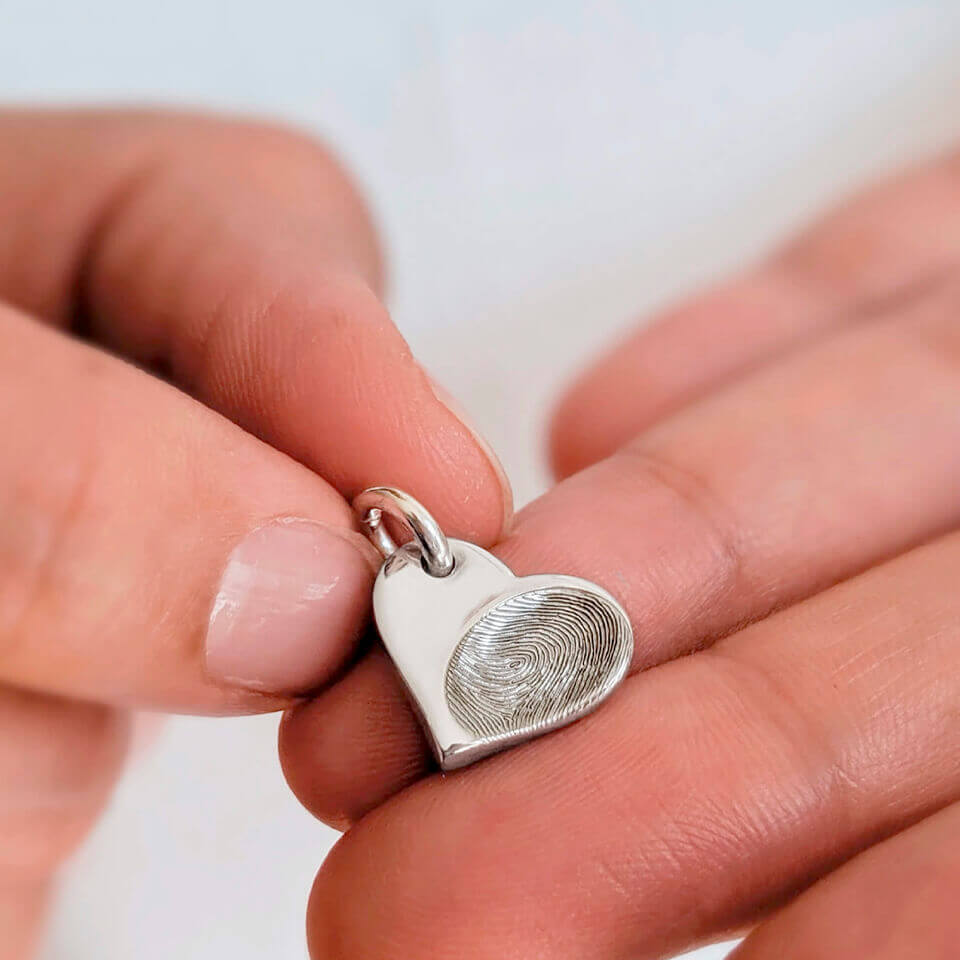 Fingerprint impression dainty heart keepsake charm in sterling silver or solid gold.