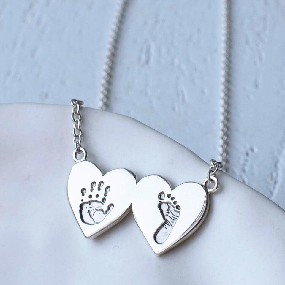 baby handprint and footprint double heart necklace in silver or gold