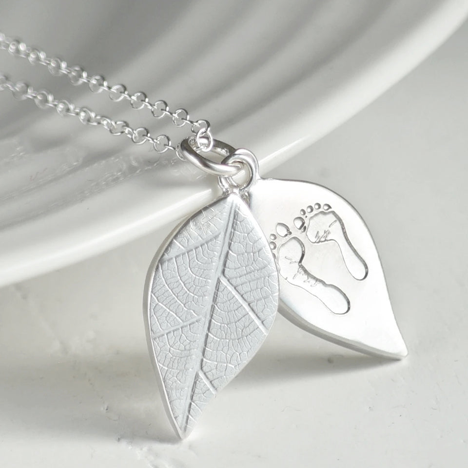 personalised children's handprint and footprint leaf locket necklace in sterling silver