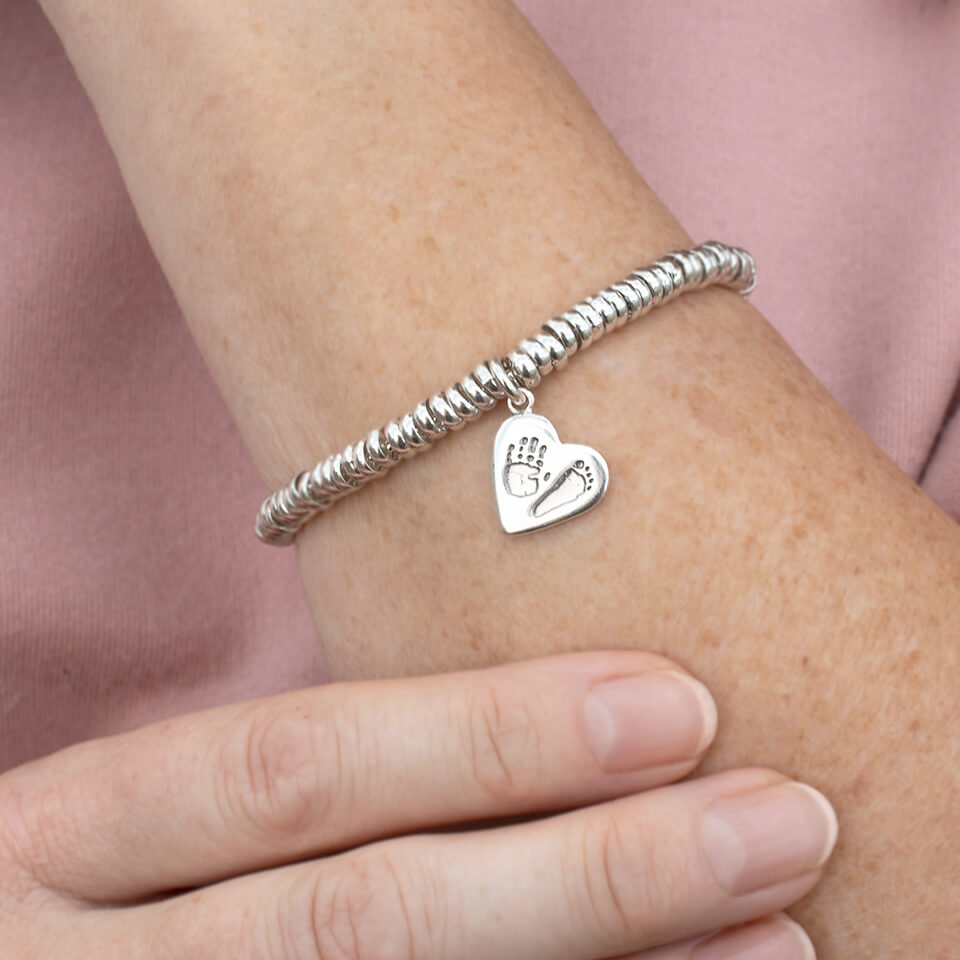 Baby handprint and footprint heart charm with silver sweetie bracelet